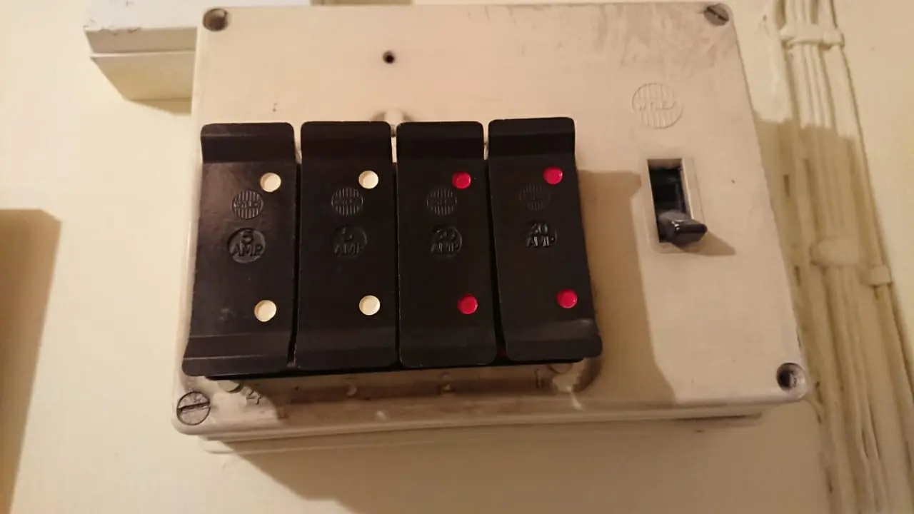 The old Wylex fuse box with four black pull-out fuse carriers