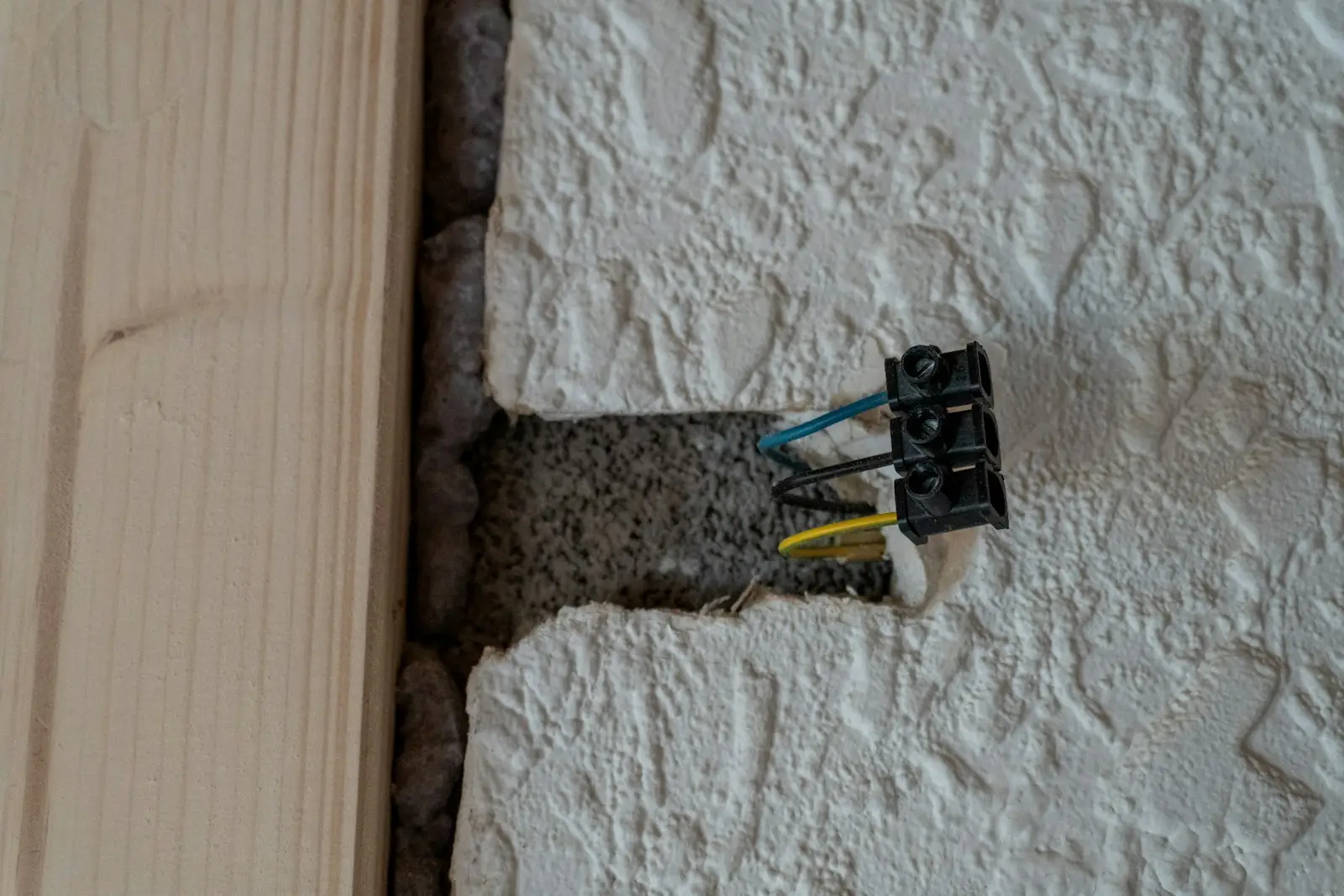 Cables pulled out of a socket box in a wall during fault finding